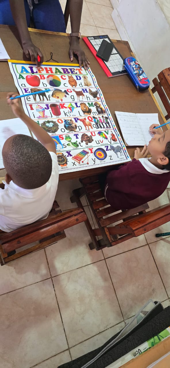 Early Years learners studying the alphabet